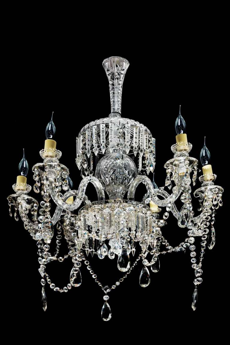 An attractive six-arm cut-glass chandelier, the central bowl under a mushroom upper section with facet cut pendant drops, the lower section with button pendant stringing and large cut pear-shaped drops.

RR.