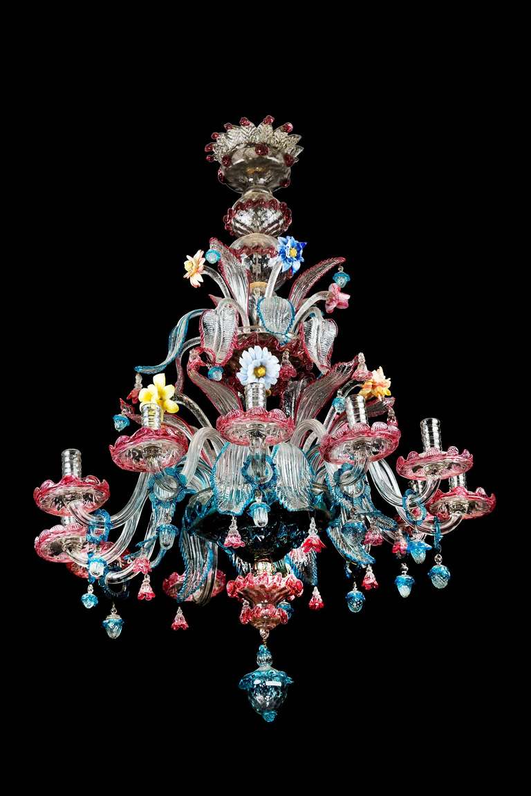 An attractive Murano Venetian Chandelier, the body with well modelled flowers and foliage in muti coloured moulded glass, the leaves edged in contrasting shading colours and hung with ovoid over-lapping drops