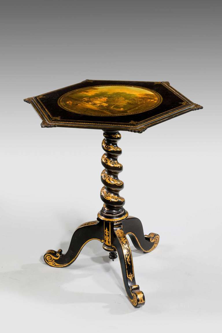 A particularly fine papier mâché occasional table the hexagonal top with delicately carved ears, the centre finely painted in the manner of William Shayer, the writhen supports with delicately gilded decoration over there cabriole legs with scrolled