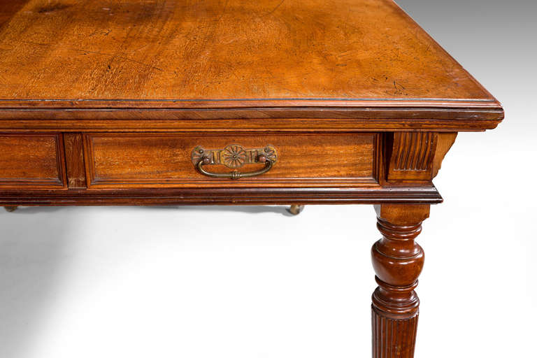 A 19th century mahogany library or writing table, with arts and crafts influence on finely turned and reeded supports.

Provenance:
C Hindley and Sons Oxford Street London Number 9597.

