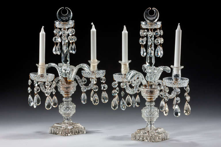 Pair of late Regency cut-glass candelabra, the two arms and stems with hobnail sections, finely cut leaves emanating from its centre stem. Restorations.