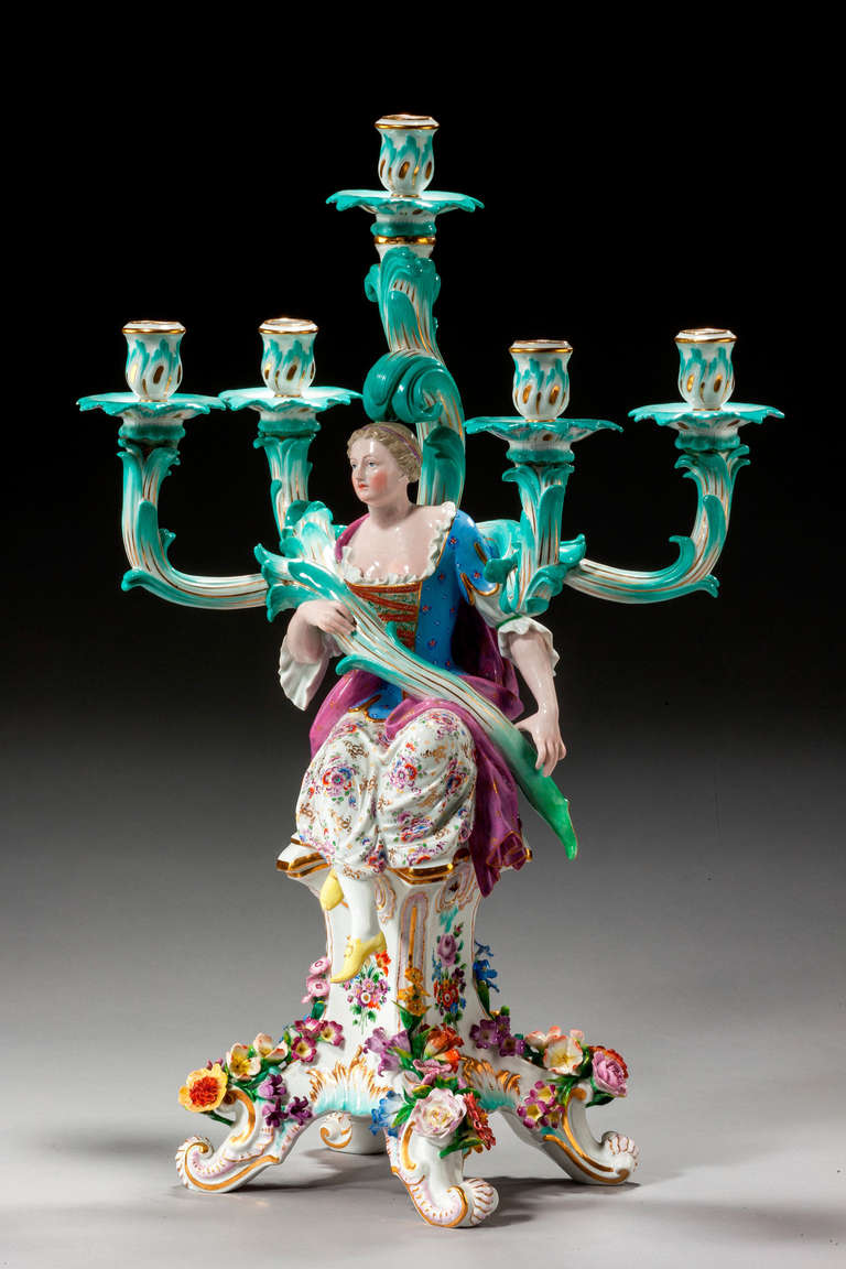 A massive Meissen five-arm candelabrum applied with scrolls and flowers.