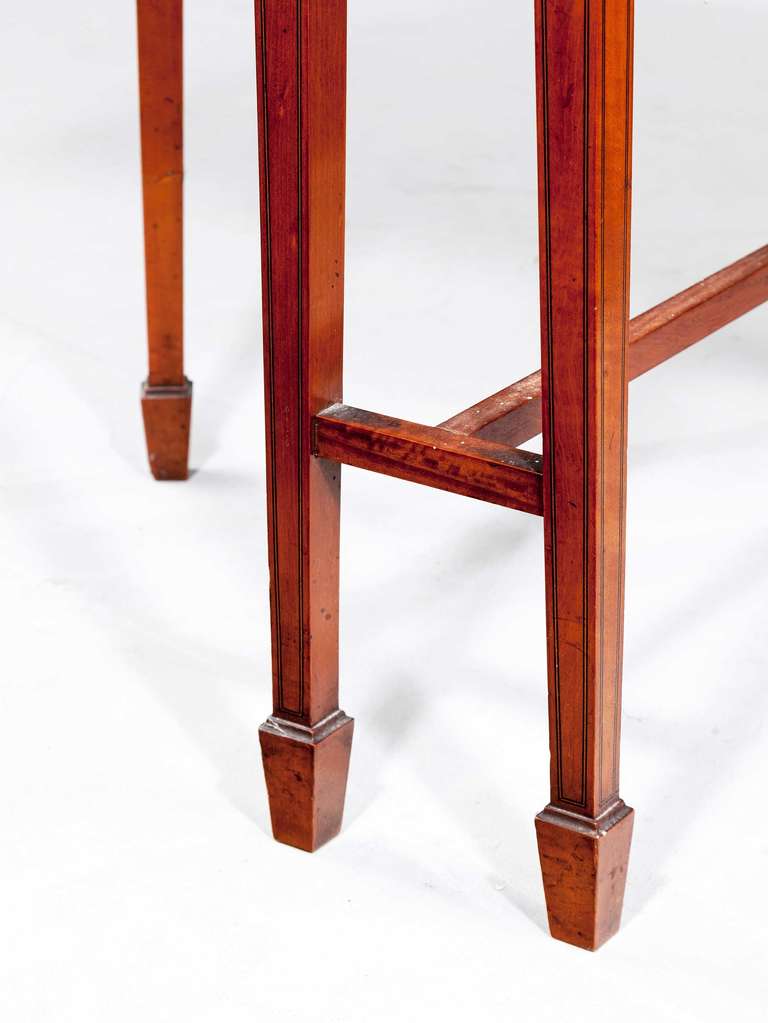 An Edwardian period satinwood Sutherland table, the top crossbanded and string, tapering supports with slender band terminating in block feet.

RR.