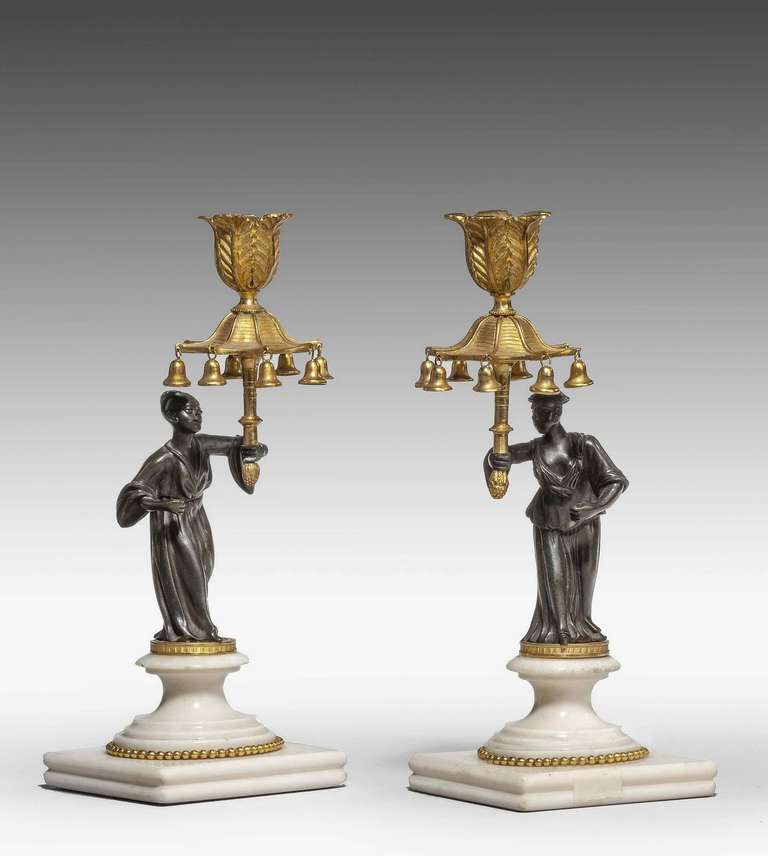Pair of Regency period bronze and gilt bronze figure candlesticks, the figures in oriental attire, canopy candleholder with bells.