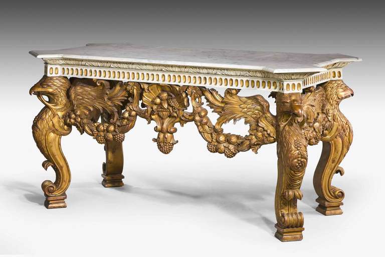 A late 19th century giltwood pier table with powerful supports and friezes of griffons over scroll terminating feet, well figured marble top, the central motif of fruits and foliage.

