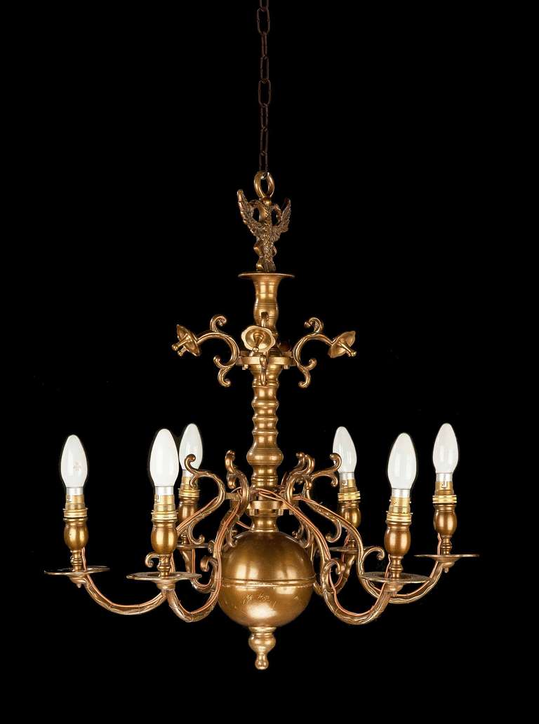 A bronze, six-arm chandelier of 17th century design, well patinated and original finish, the upper section of arms convolvulus, centre turned supports.

