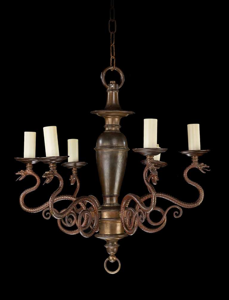 An unusual six-arm chandelier, the large, well turned baluster centre support holding the arms in the form of cast serpents.

