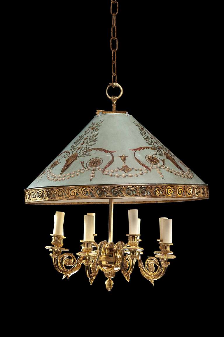 A rare gilt bronze and tole chandelier with six well cast and chiseled scroll arms under a tent shaped decorated shade, the shade incorporating cast and chiseled scroll border.

RR.