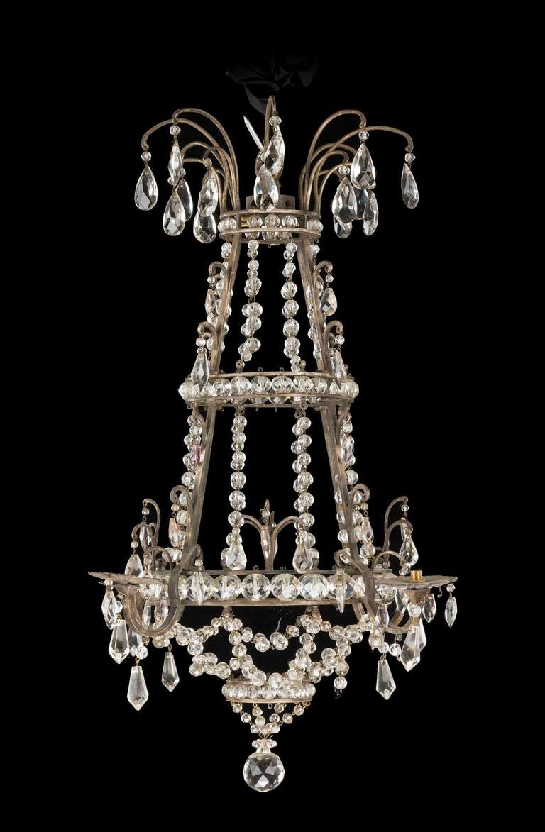 19th century gilt bronze and crystal chandelier, the top section with suspended pear drops. The gilt bronze uprights joined with tiered levels of crystal lozenges.

