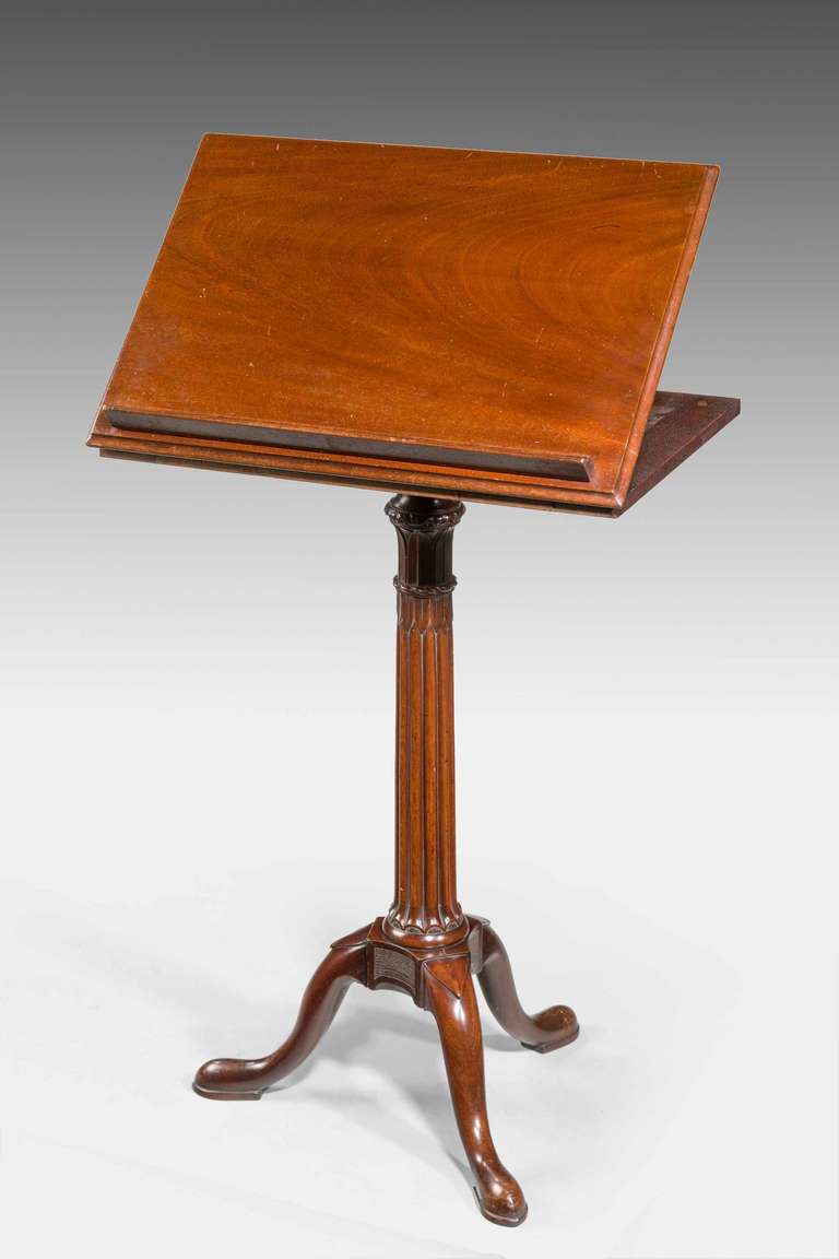 An elegant Chippendale period mahogany reading/writing table on very well carved central tapering support, the block over the feet with inset 'punched' panels, the double ratchet adjustable.

