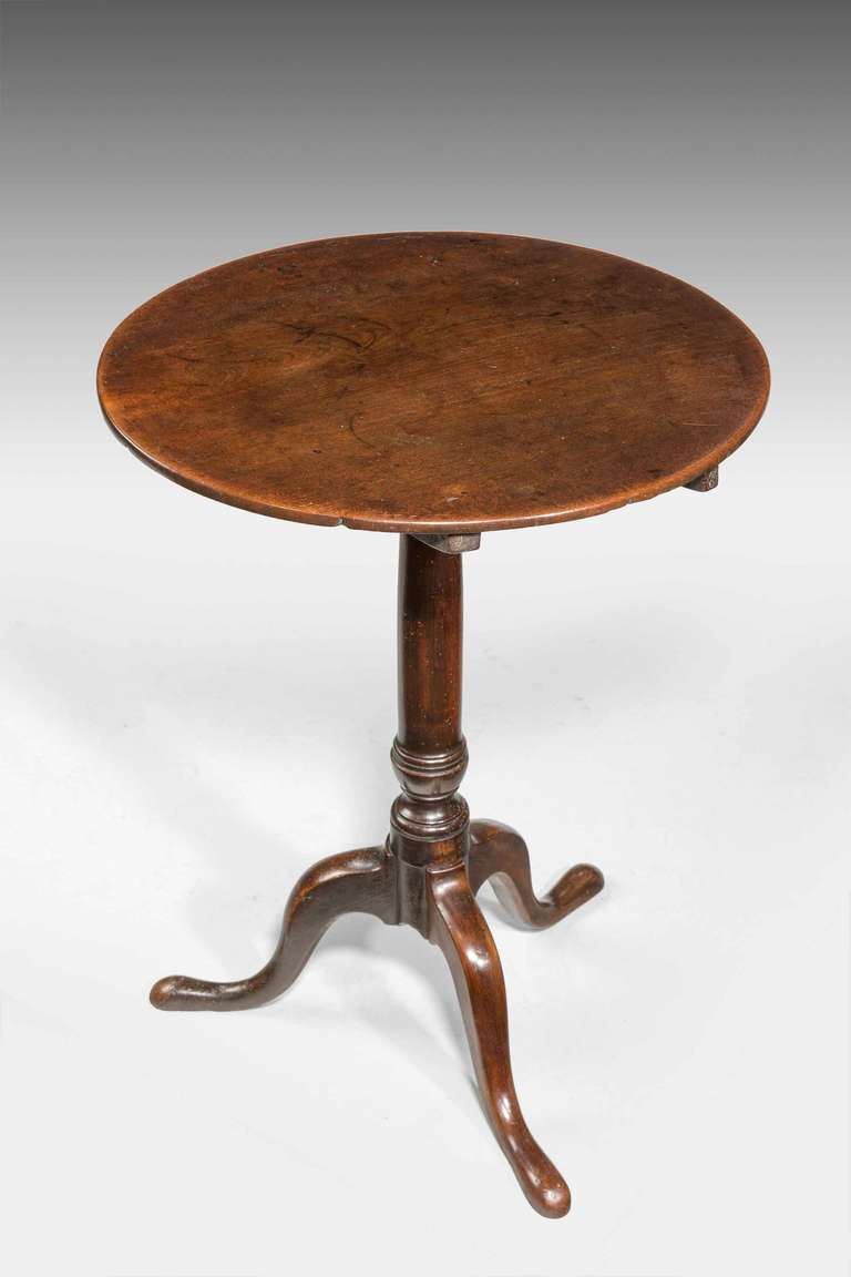 George III period mahogany tripod table on gun barrel support standing on three pad feet, the block with restorations.