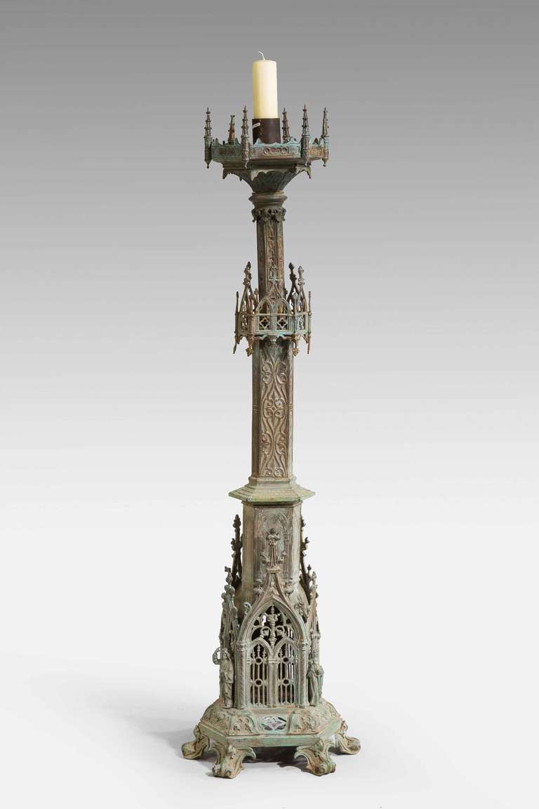 A massive bronze 19th century Gothic candlestick with elaborate chiselled and pierced decoration, well defined green patination.