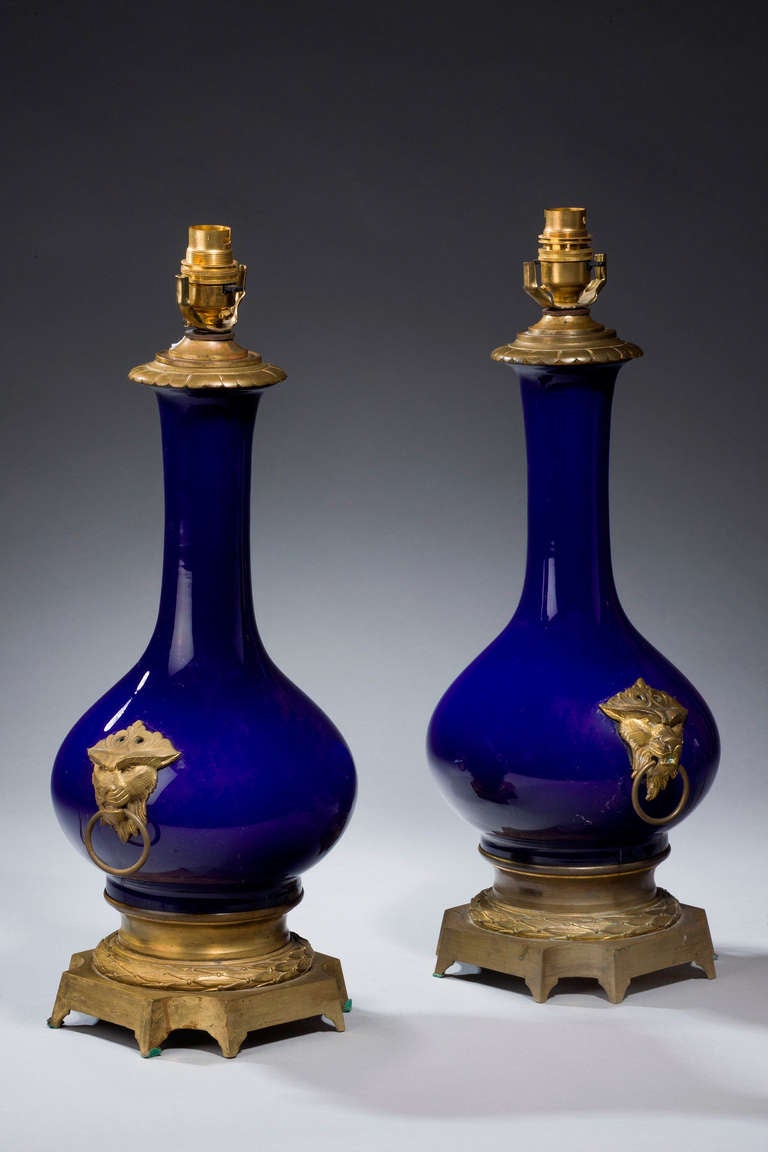 Pair of blue porcelain and gilt bronze lamps with original gilt bronze mounts with leopard handles.

Shades are not included in the price of our lamps. We do have a competitively priced range of shades for all of our lamps. Please ask for details