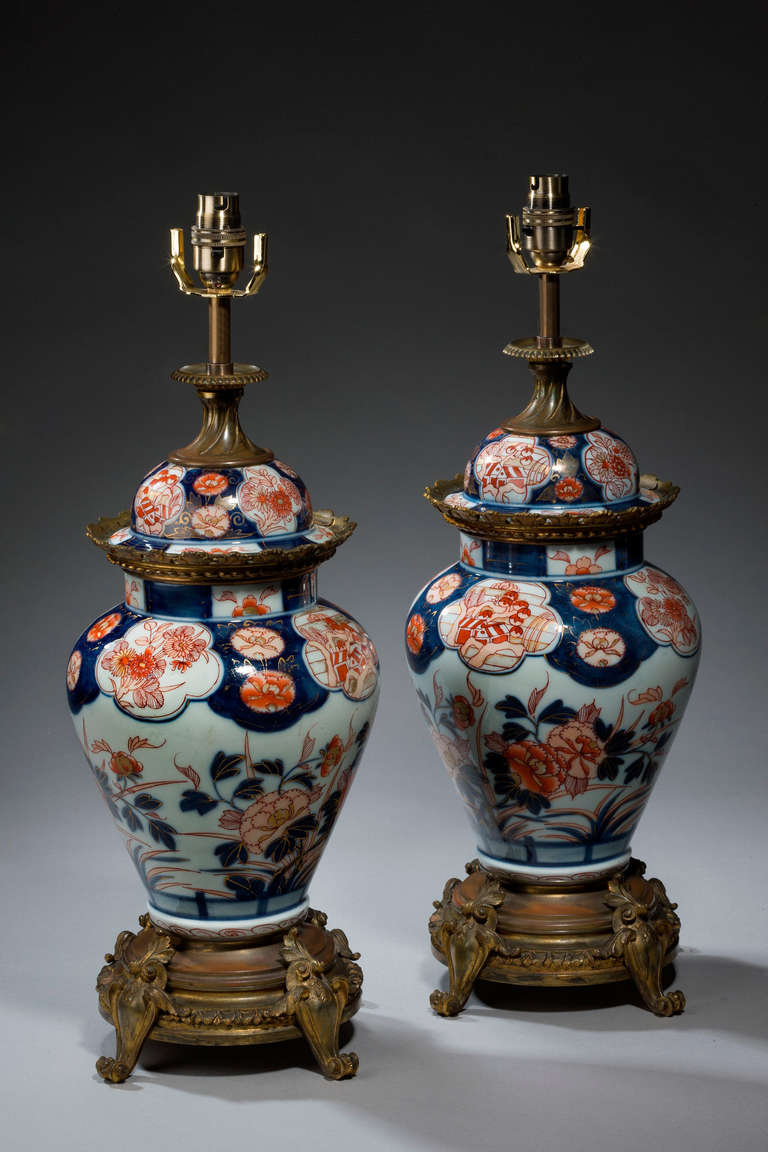 Pair of Japanese Imari porcelain Oil Lamps, now converted into electricity, of ovoid form, dome topped and base bronze mounts.

Imari began to be exported to Europe, because the Chinese kilns at Ching-te-Chen were damaged in the political chaos