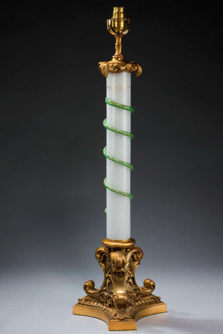 Good French opaline and bronze column lamp, the stem with a green, gilded applied serpent on elaborate triform base.

Shades are not included in the price of our lamps. We do have a competitively priced range of shades for all of our lamps. Please