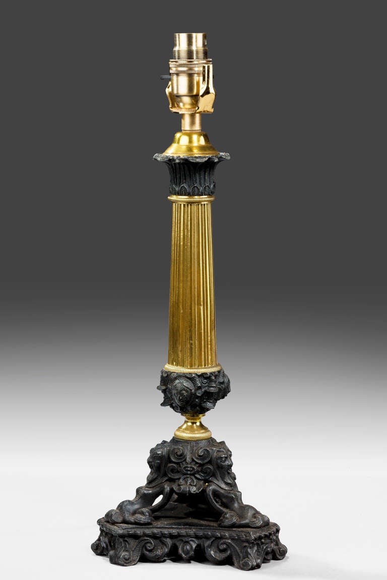 19th century bronze and gilt bronze column lamp on a cast and chiseled triform base.

Shades are not included in the price of our lamps. We do have a competitively priced range of shades for all of our lamps.

RR.