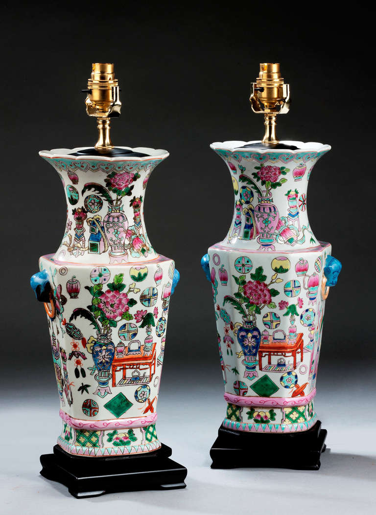 Pair of Canton design pottery Vase lamps of octagonal form with panels of tables, flowers and foliage. Modern.

Canton porcelains are Chinese ceramic wares made for export in the 18th to the 20th centuries. The wares were made, glazed and fired at