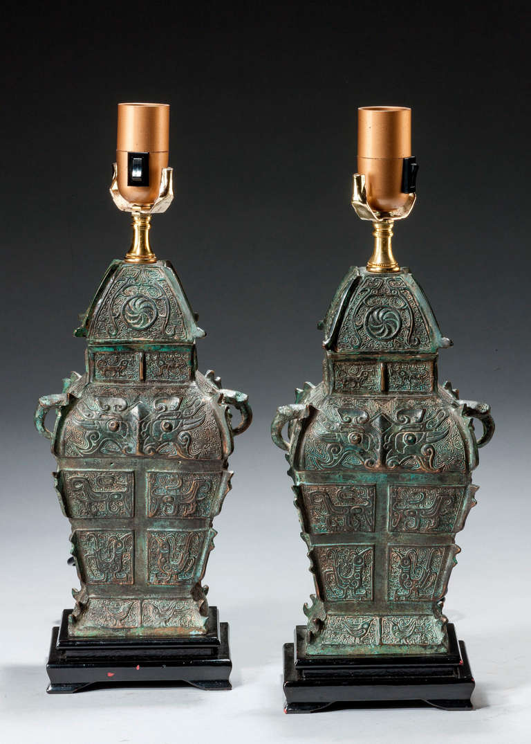 A pair of 'archaic' bronze square section lamps, with elaborate decoration. Modern.