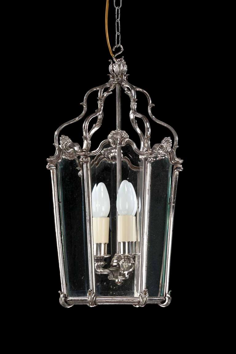 A delicate silvered bronze, six pane lantern, the scroll support to the top sections joining wavy tops to glazing.