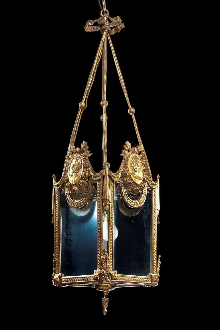 A fine cast and chiseled French gilt bronze Lantern, the corners with tassels and main panels with neo-classical cast and chiseled heads.

RR