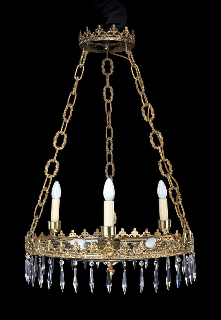 A Regency style, large cut glass Plafonnier with cut and chiseled gilt bronze border over suspended cut drops, finely cast chains to the upper support.