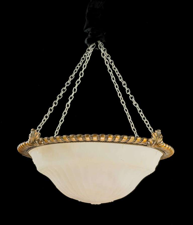 A gilt bronze Plafonnier, the dished milk glass centre shaped and with ribbed decoration.

