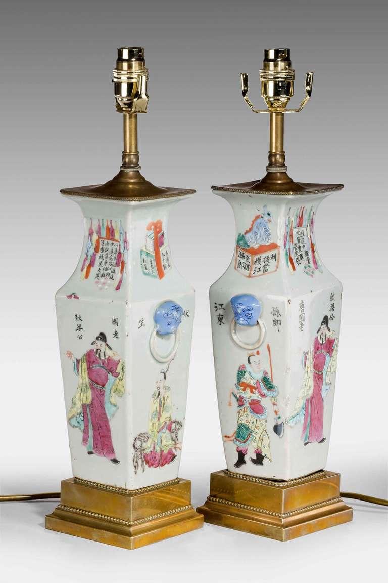 Pair of 19th Century Cantonese square section Vases, now electrified, the main body with court figures, the upper section with poems, applied turned handles on good French gilt bronze bases.