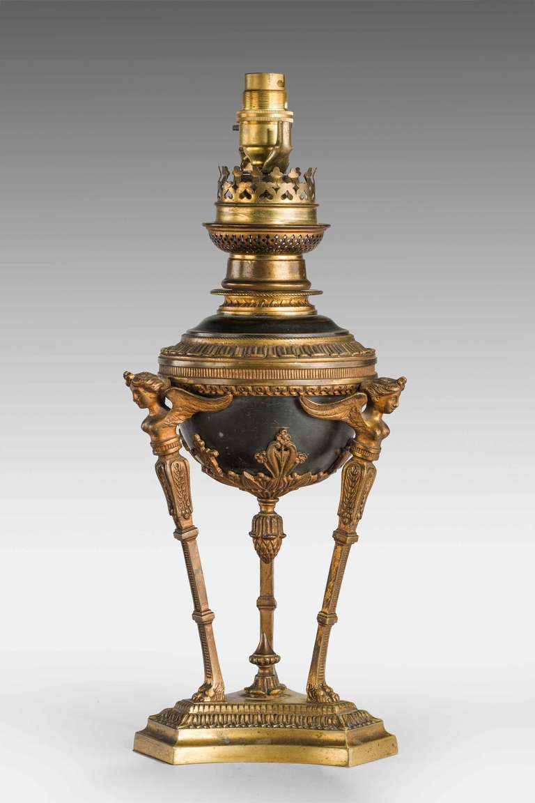 A Pair of 19th Century gilt bronze Oil Lamps, now electrified, the triple supports with female upper sections terminating in hairy paw stepped triform bases, elaborately chiselled.

Shades are not included in the price of our lamps. We do have a