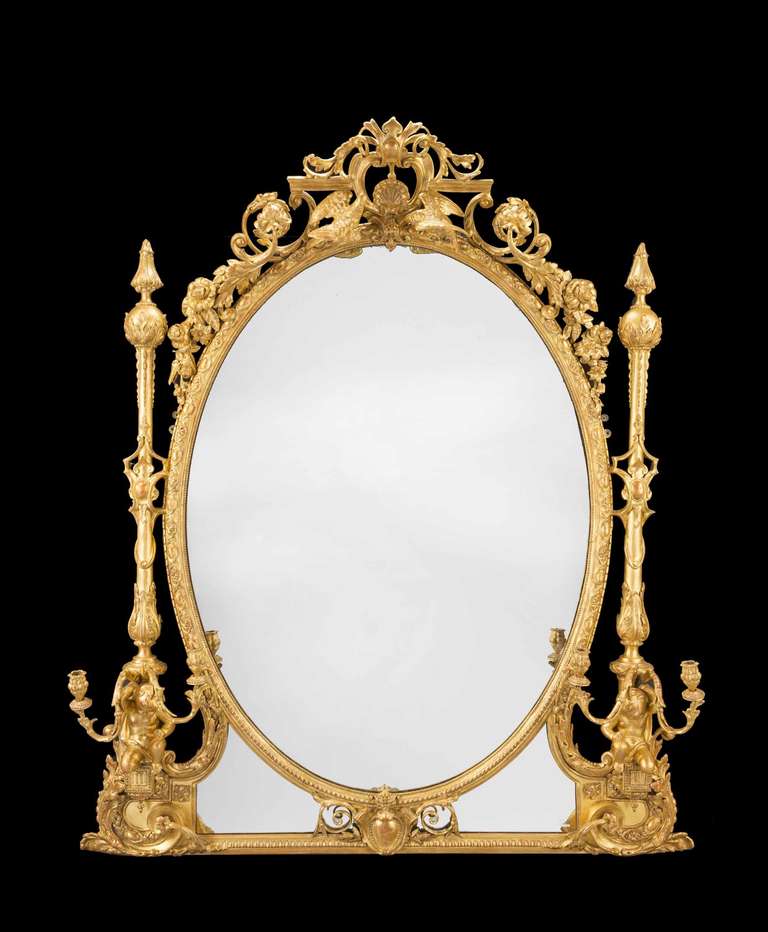 An exceptional 19th century giltwood and gesso overmantel mirror, the base section with a pair of putti holding candelabras, the pediment with doves surrounded by scrolls and foliage.

RR.