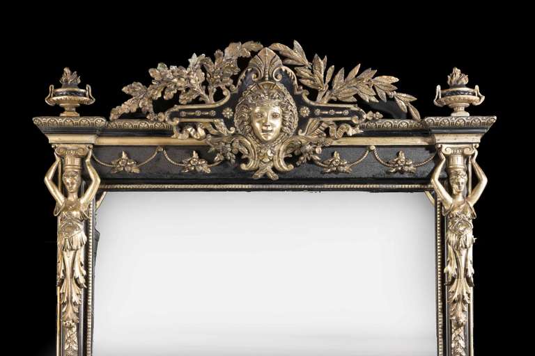 An unusually large mid-19th century Italain ebonized and silvered mirror, with finely carved neoclassical maidens, the uprights with carved fruits and foliage.

