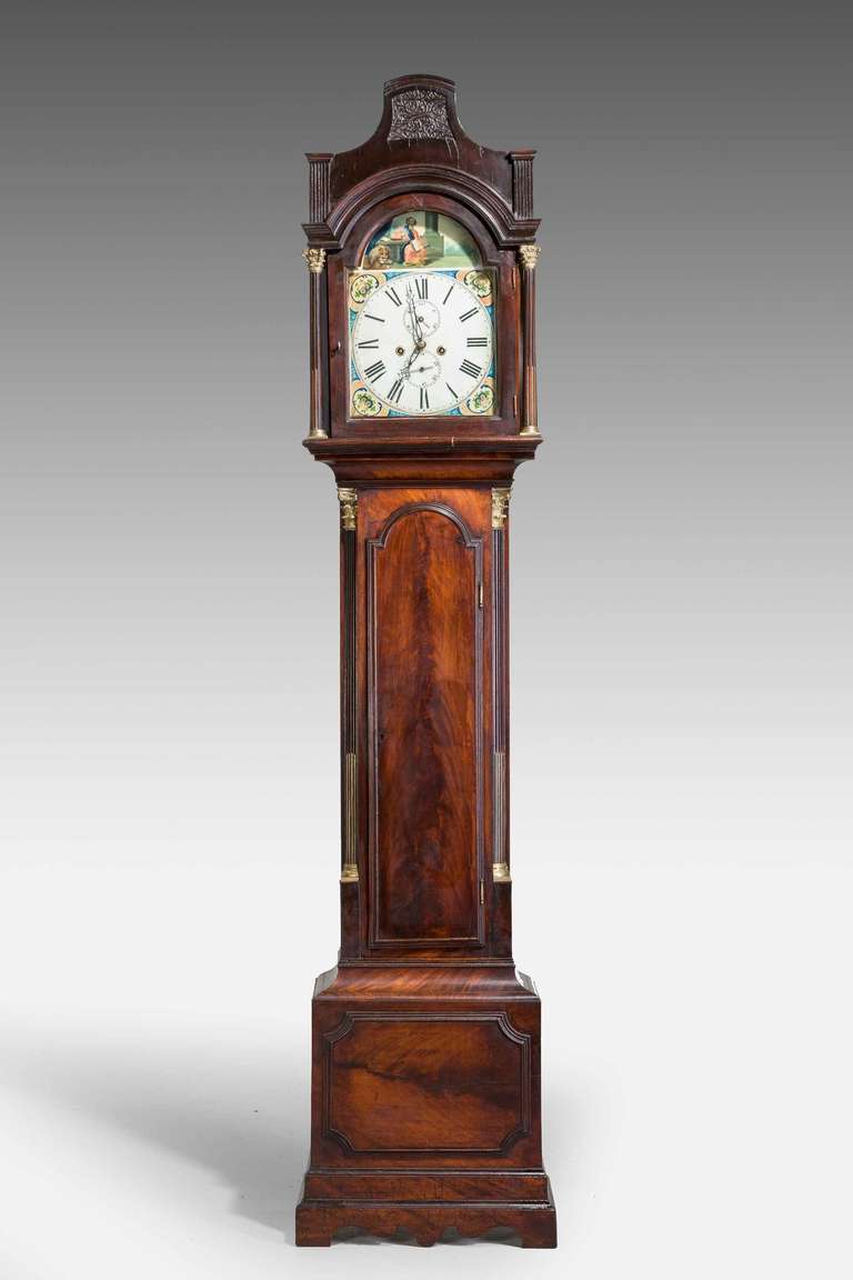 19th century mahogany painted dial long case clock, particularly finely figured, arched dial with an eight day movement and two sub sequential dials, upper case with finely cast quarter columns, top with fine blind fret apertures. Unsigned.

