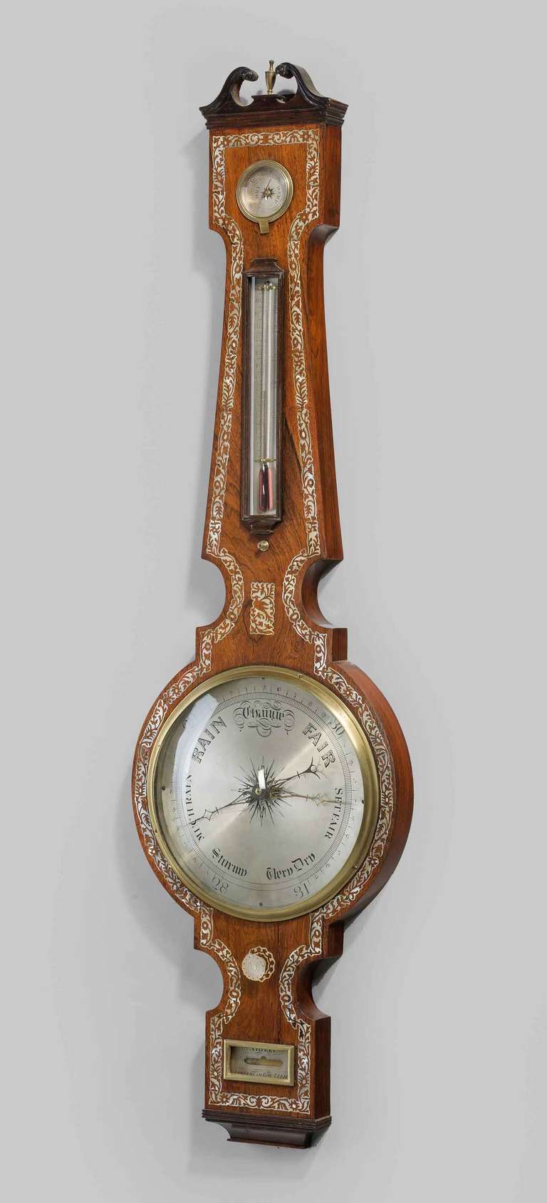 A very fine late Regency period ten in dial barometer by Arizzi of Leeds, with mother-of-pearl decoration, silvered dial, thermometer, hygrometer, spirit level, having a swan neck pediment with a brass finial.

Arizzi. Lower head row. Leeds,
