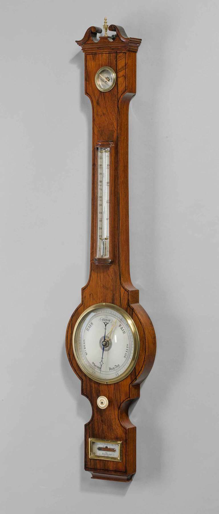 A very fine Regency period 6 ins dial Barometer by Robinson of Bradford, with ebony line decoration, silvered dial, thermometer, hygrometer, spirit level, having a swan neck pediment with a brass finial.

Dan Robinson of Bradford. Yorkshire.

