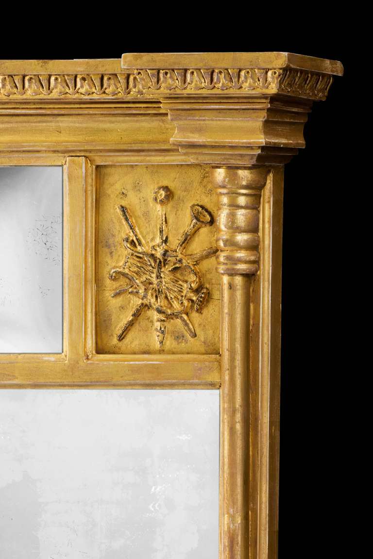 A small Regency period giltwood pier mirror, the left and right-hand uprights of column form, the top section with two carved giltwood panels portraying the arts, flared top border with well carved decoration.

RR.