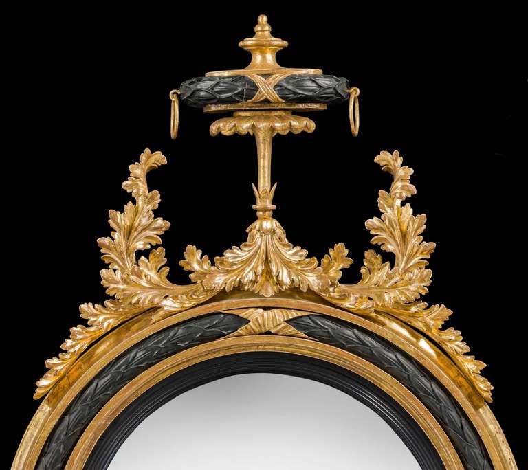 English Regency Period Convex Mirror with Ebonized and Giltwood Decoration