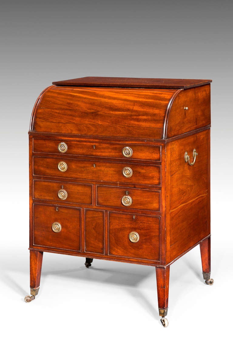 A late 18th century mahogany cylinder bureau of small size, the interior with a folding writing slide below pigeon holes, square tapering supports with brass shoes and castors.

RR.