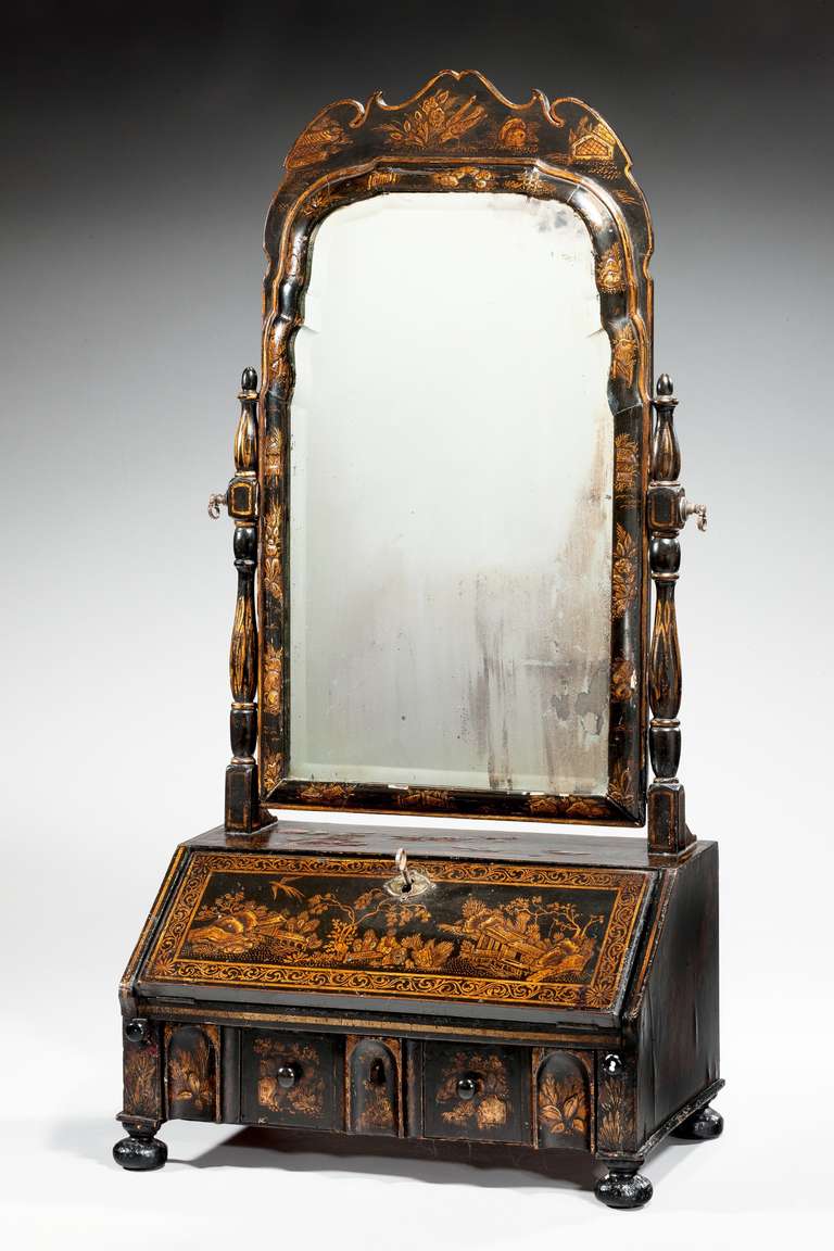 Queen Anne period lacquered dressing mirror, the sloped front enclosing drawers and pigeon holes standing on bun feet.
