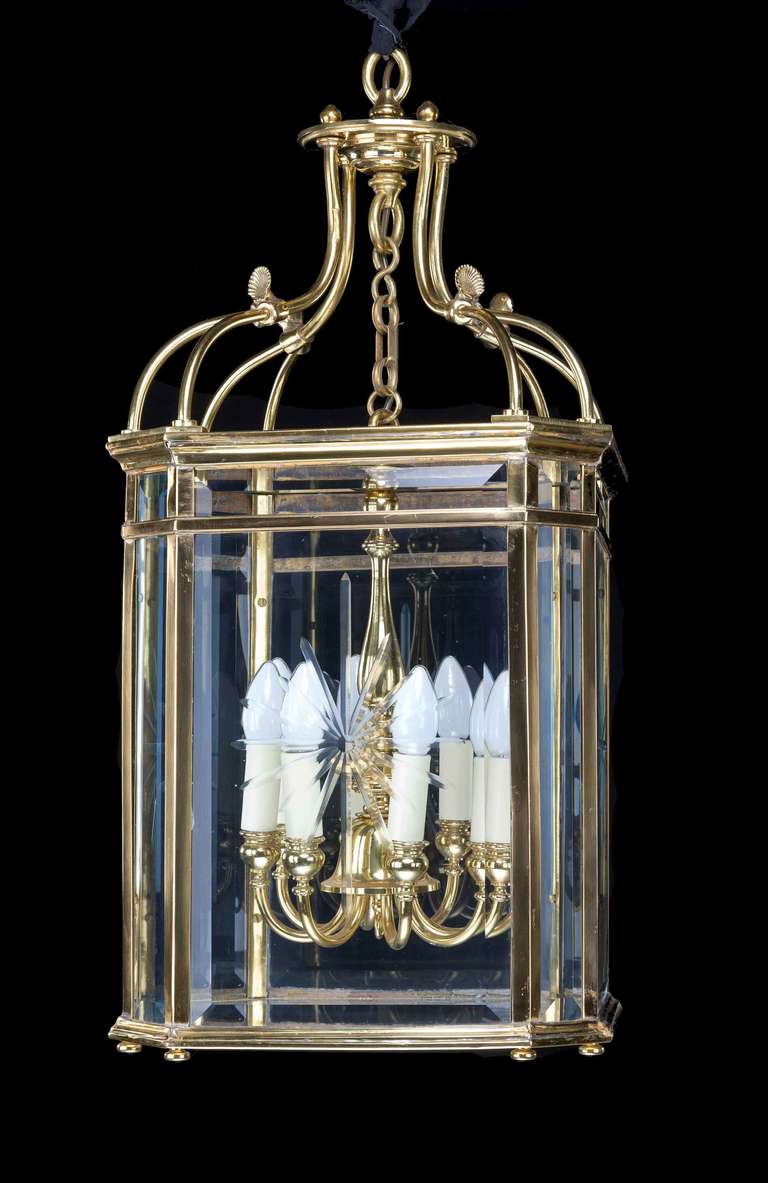 A very good gilt bronze Regency style lantern with four large and four small windows, all bevelled, the centre light with eight arms, the upper support scrolls with applied decoration, the whole of excellent quality.

RR.