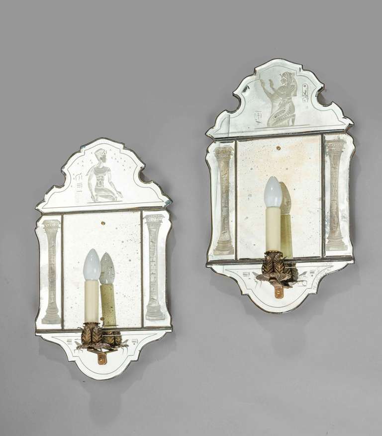 Pair of Mid 20th Century Wall Lights, the backs mirrored in a dark metallic glass. Complex bevel edges with Egyptian-esque columns and kneeling God.
