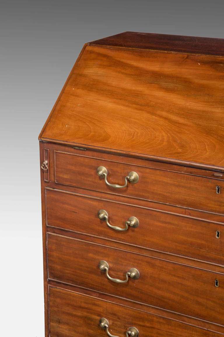George III period mahogany bureau with an attractive interior with pigeon holes and a central secret compartment with original swan neck handles.