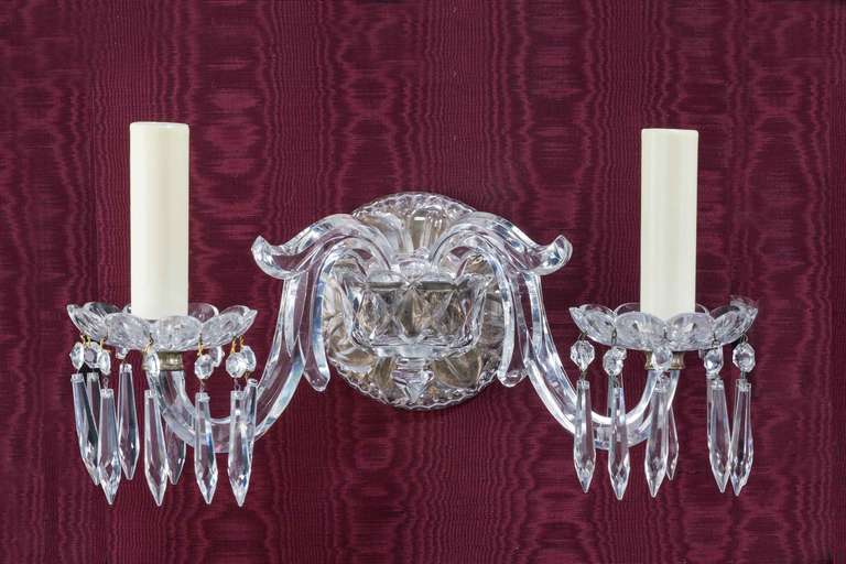 Most unusual and attractive set of four late 19th century glass wall lights, the main bodies with faceted and leaf shaped cuts, the octagonal swept arms supporting shaped bowls with suspended drops.

RR.