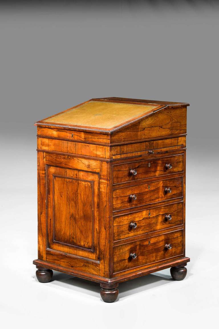 Good Regency period Davenport Desk of sophisticated form the beautifully figured timbers with ebony line inlay incorporating a slide and original turned wooden knobs.

Provenance
A Davenport , (sometimes originally known as a Devonport desk) is a