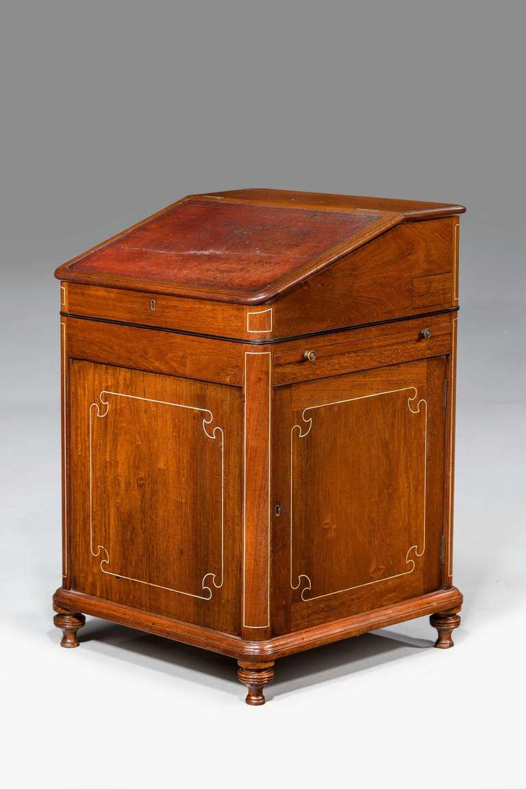 An early 19th century Anglo-Indian teak Davenport with fine line bone inlay.

Provenance:
A Davenport, (sometimes originally known as a Devonport desk) is a small desk with an inclined lifting desktop attached with hinges to the back of the body.
