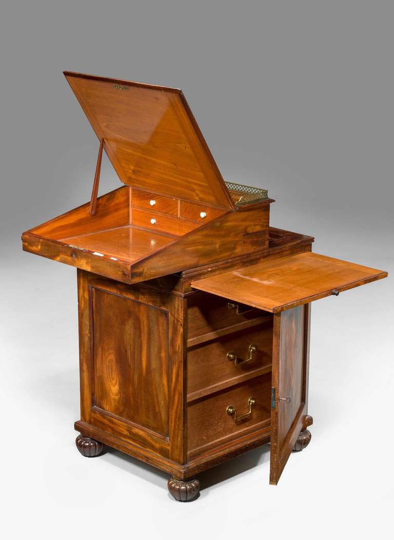A Good Regency period mahogany Davenport Desk, the door concealing three fitted drawers and with a slide on original toupee feet.

Provenance
A Davenport , (sometimes originally known as a Devonport desk) is a small desk with an inclined lifting