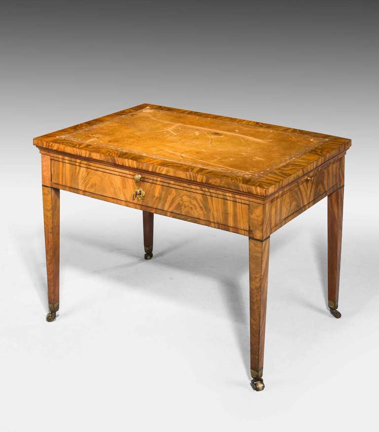 A fine and original Louis XVI well figured mahogany architects/ draftsman’s table with writing and drawing sections on the original ratchet supports. The ends incorporating leather top slides, stamped Champuis.

  