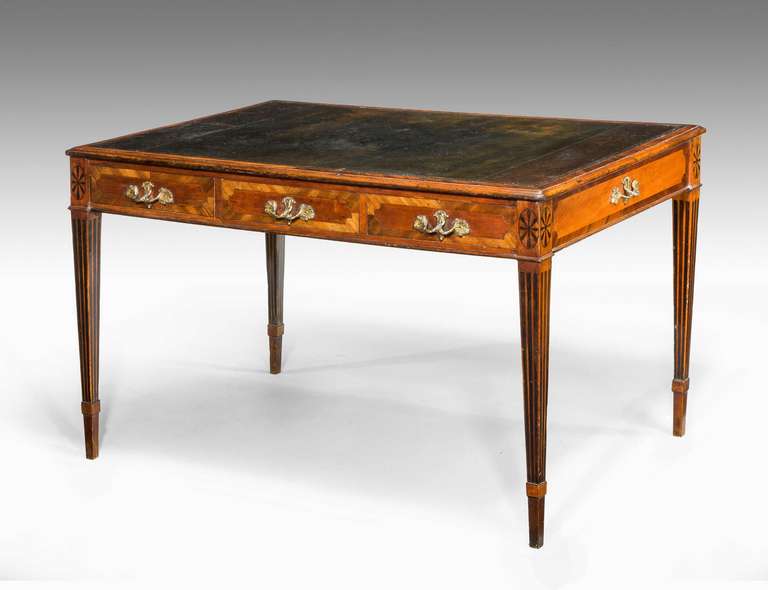 An exceptionally fine George III period mahogany writing table with inset leather writing surface with rounded edges to the top, fine tapering square supports with box sections, inlaid with wavy ebony line and oval patera. The finest and original