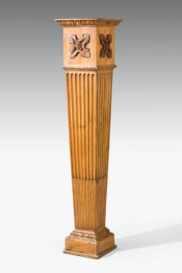 A good pine pedestal with deeply incised centre section, the top section with applied carving on a well carved square section base.

RR.