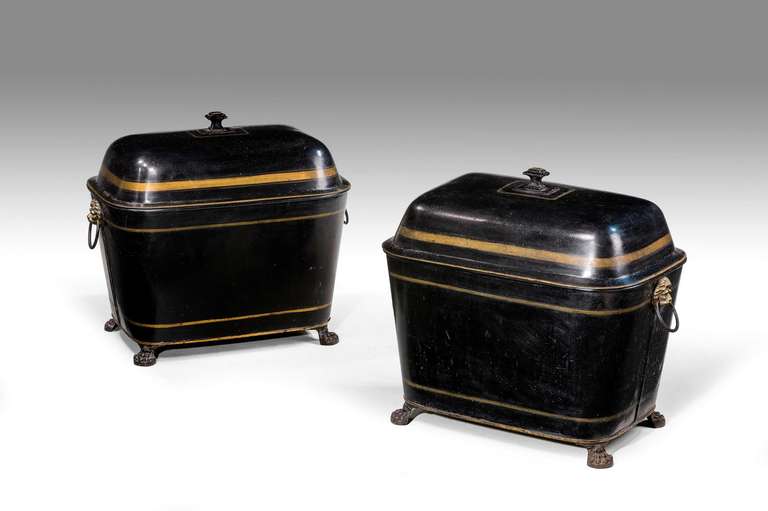A pair of decorated early 19th century log bins, the rectangular form with shaped domed tops; the gilded decoration original with lion mask handles and paw feet.

RR.