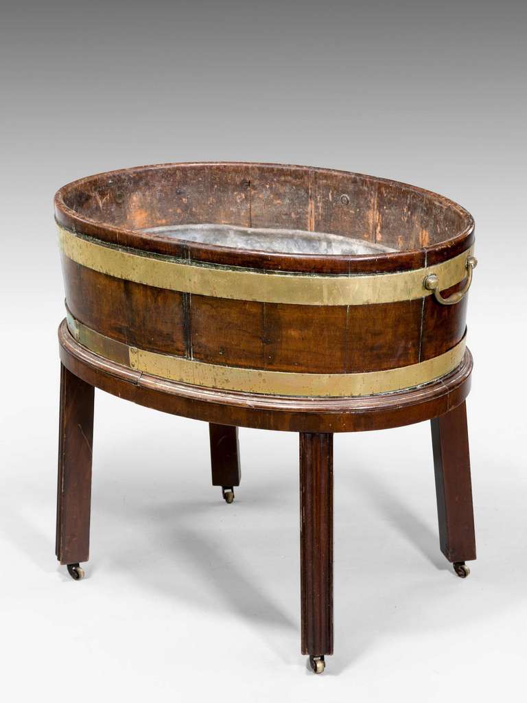 George III period oval wine cooler fitted on chamfered square supports.

RR.