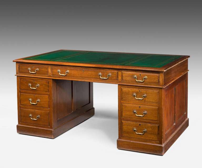 Early 20th century mahogany pedestal desk, with fielded drawer fronts with a rounded top edge, the pedestals with panels and in overall good condition.

